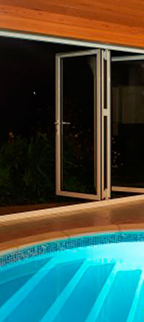 tall smarts aluminium bifold door with pool night